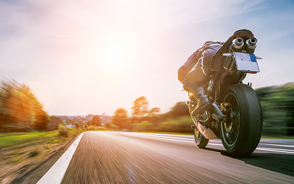 a motorcycle driving a speed through the countryside