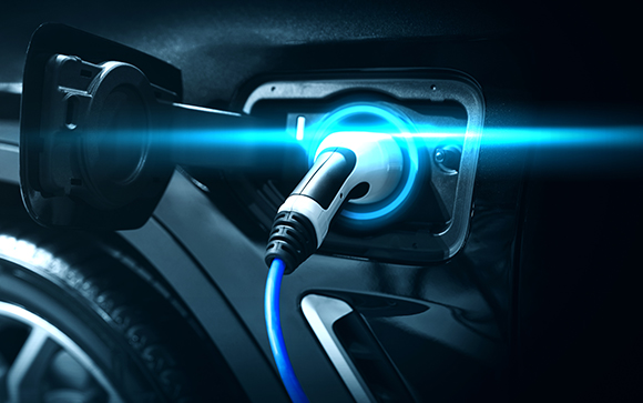an electric car with it's charger inserted into its socket